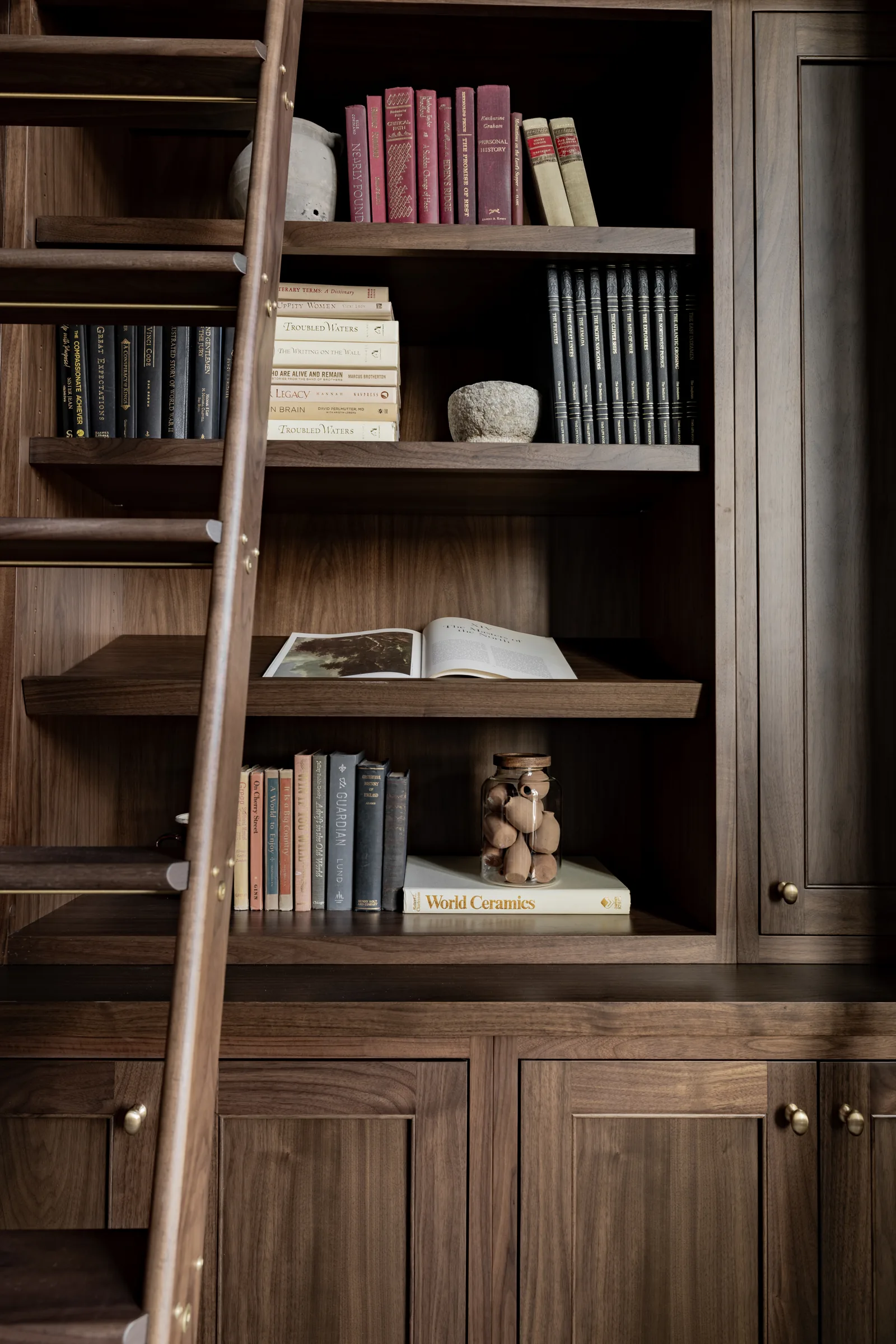 Walnut library shelving with a rolling ladder