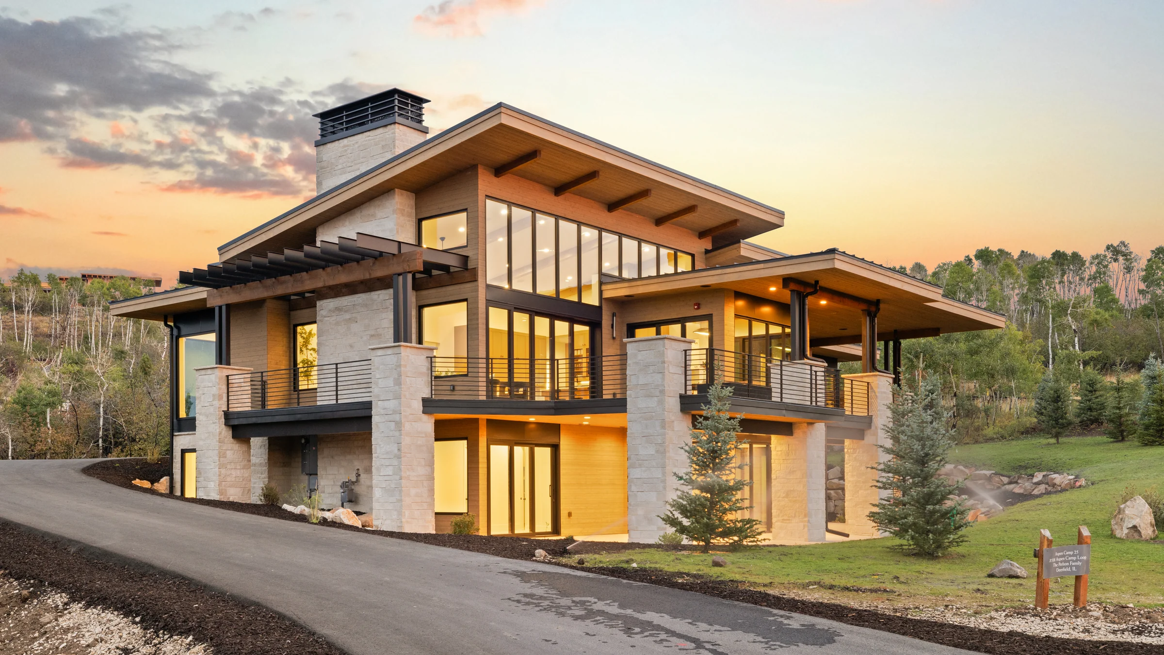 Hillside home at dusk, interiors lit — brand film still